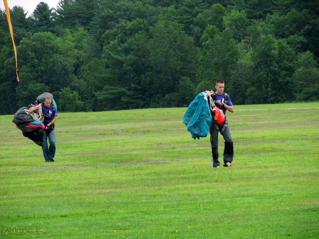 After the fall - Skydivers team leaves the field after a test jump